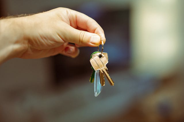 person holding set of keys